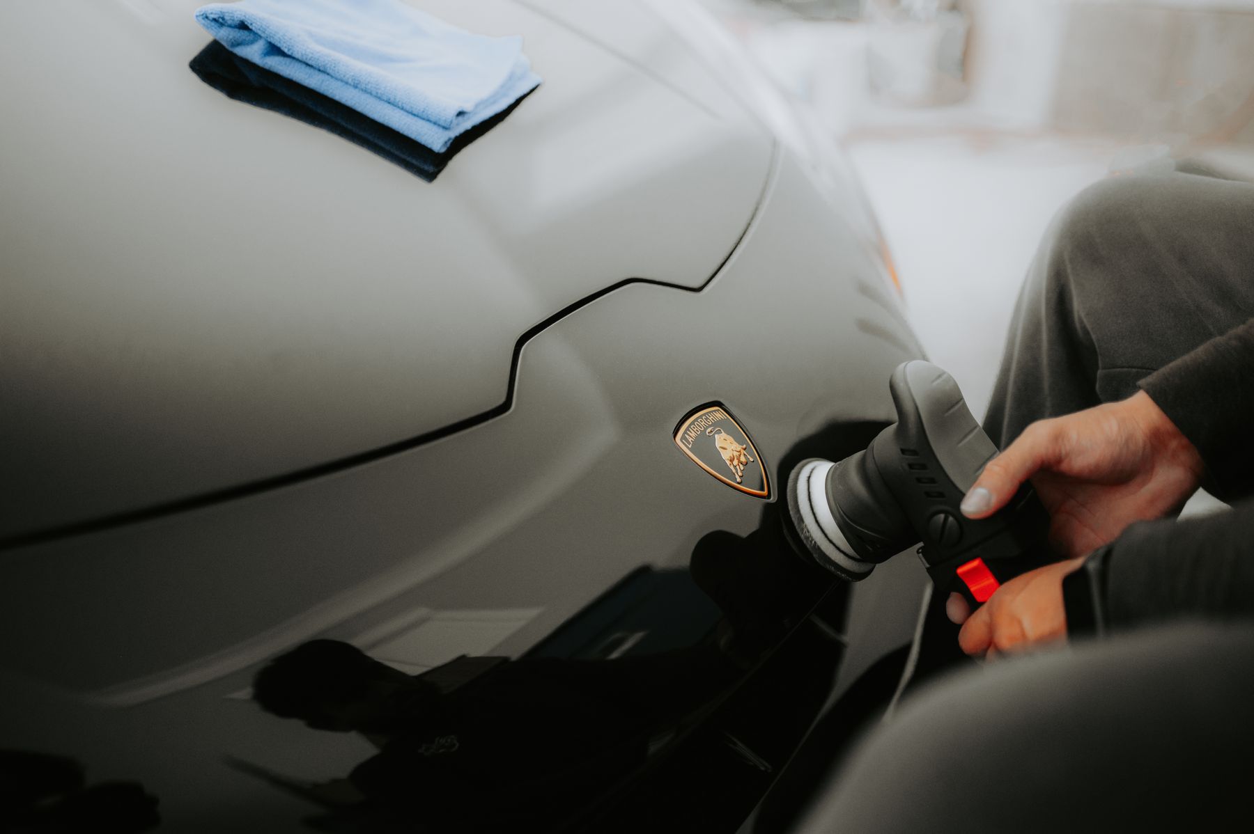 Professional machine polishing performed on a black Lamborghini